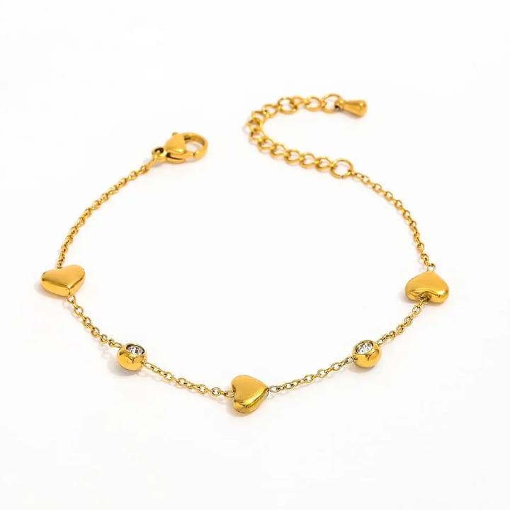 “Golden heart‑beat bracelet with sparkling gems – wear love in every link 💛✨"