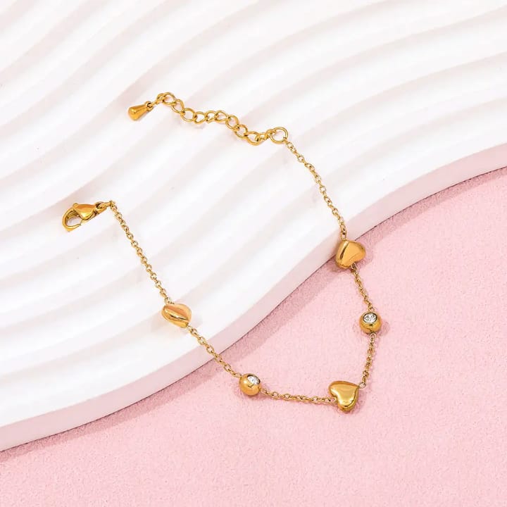 “Golden heart‑beat bracelet with sparkling gems – wear love in every link 💛✨"