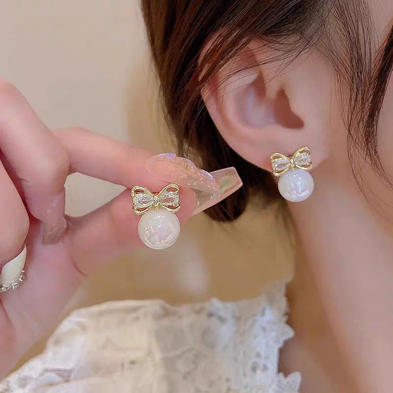 “Elegant bow & moonstone charm ✨—the perfect touch of sparkle for every ear.”