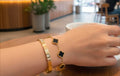 “Golden duo – sleek bangle & clover bracelet"