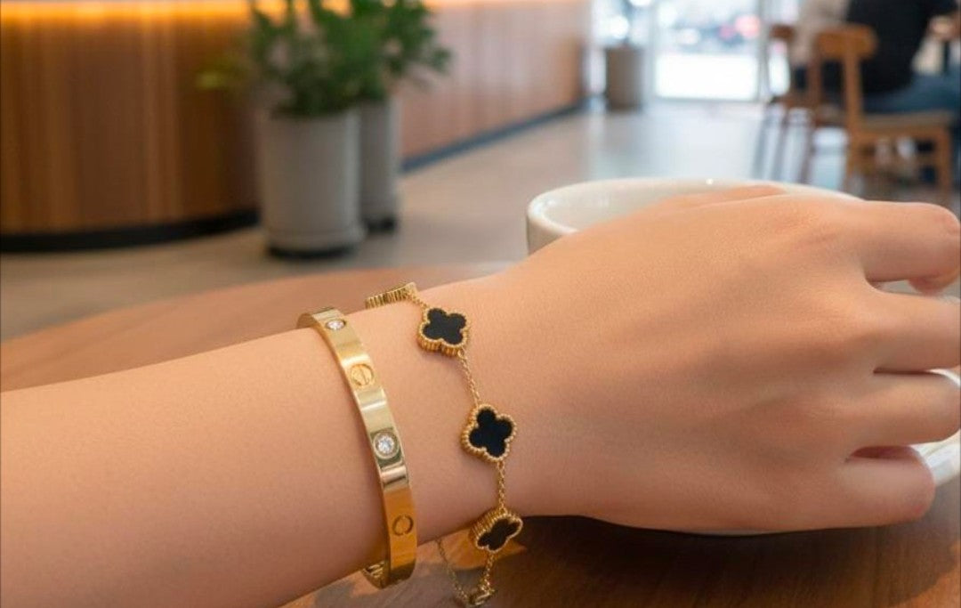 “Golden duo – sleek bangle & clover bracelet"