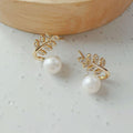 “Elegant leaf‑shaped earrings with sparkling zirconia and a classic pearl drop ✨— timeless chic for every occasion.”
