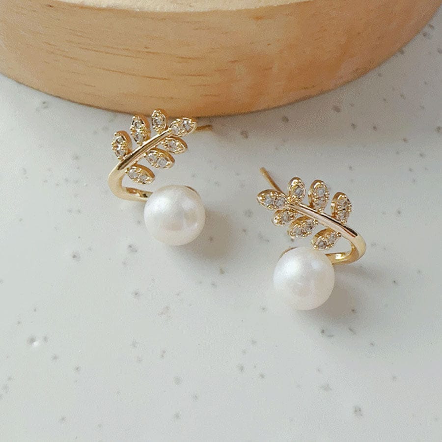“Elegant leaf‑shaped earrings with sparkling zirconia and a classic pearl drop ✨— timeless chic for every occasion.”
