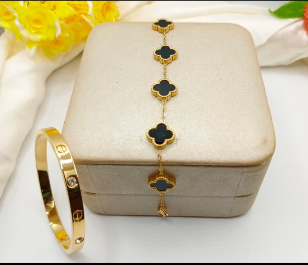 “Golden duo – sleek bangle & clover bracelet"