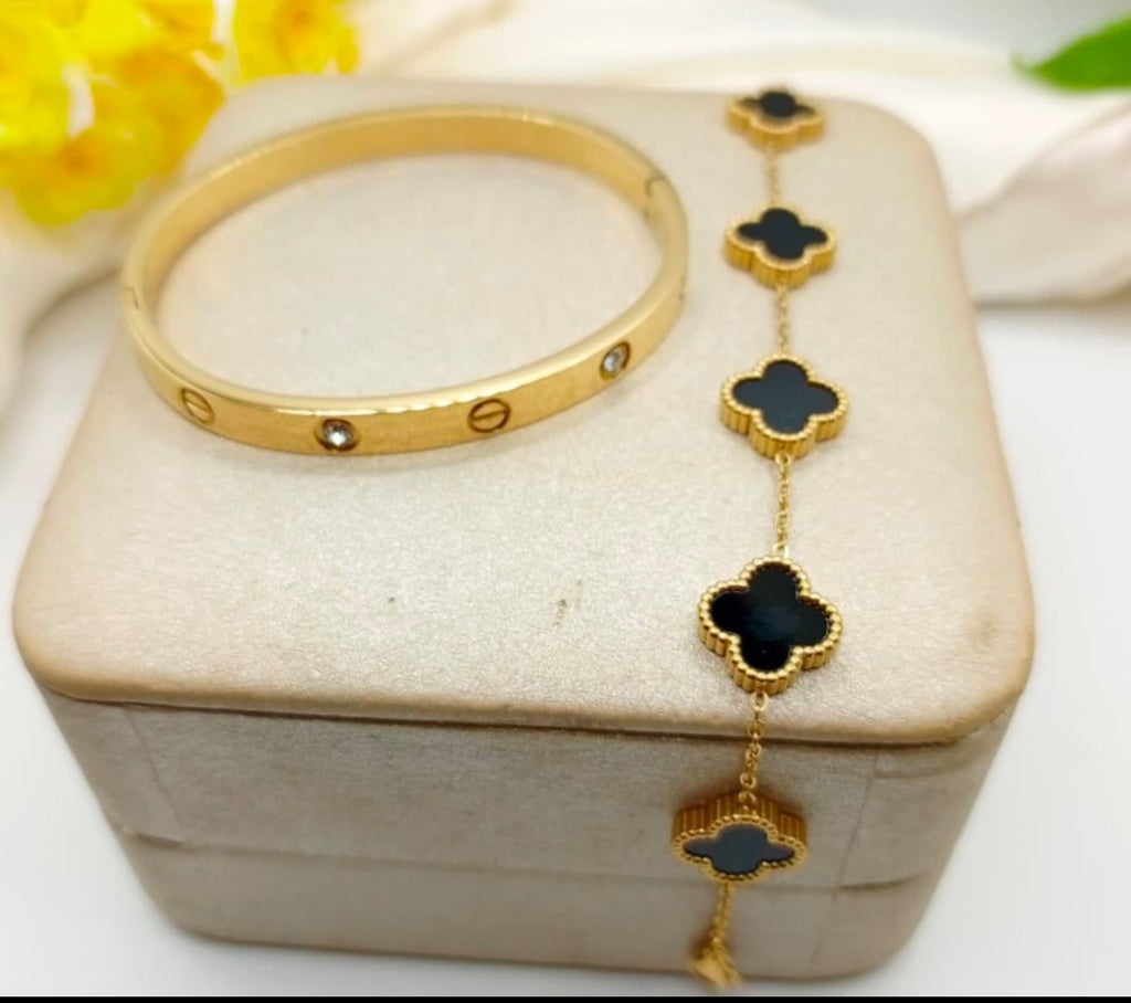 “Golden duo – sleek bangle & clover bracelet"
