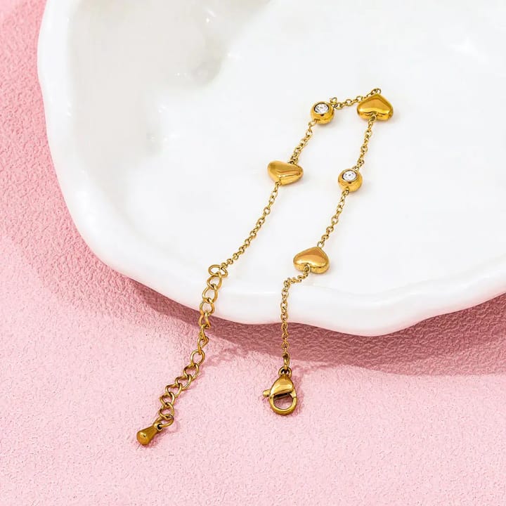 “Golden heart‑beat bracelet with sparkling gems – wear love in every link 💛✨"