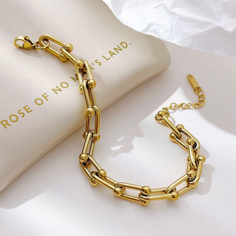 “Not just a bracelet — a statement ✨ Where bold links and golden orbs meet timeless style"