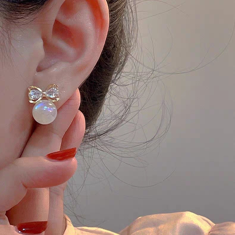 “Elegant bow & moonstone charm ✨—the perfect touch of sparkle for every ear.”