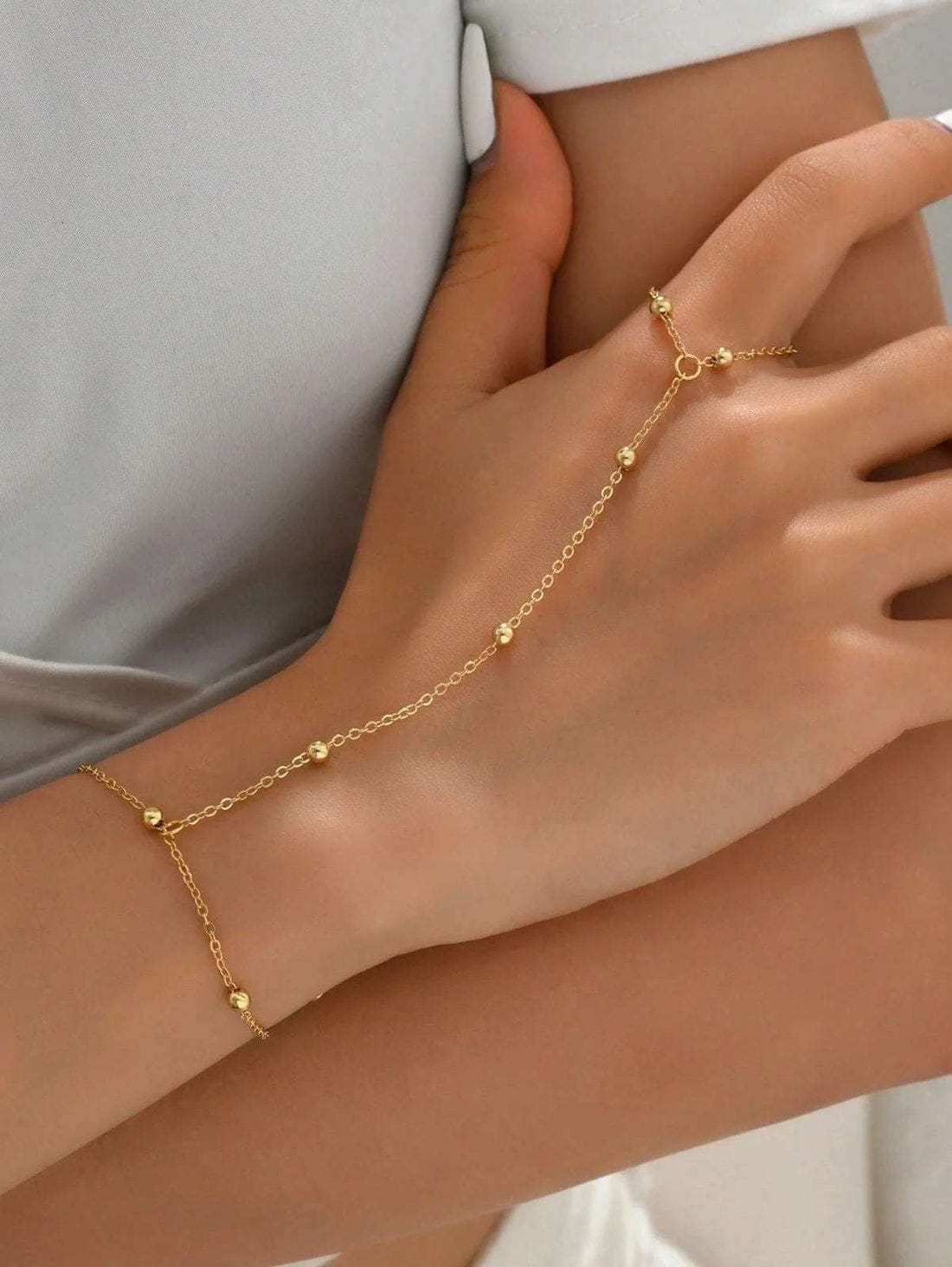 “Delicate details, bold statement ✨ This gold hand chain adds the perfect touch of luxe to any look "